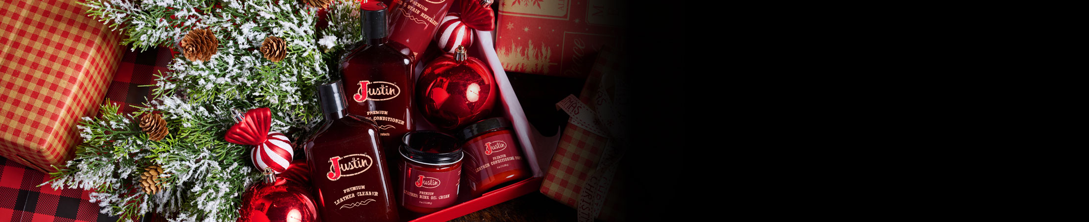 Bottles and jars of boot leather cleaner in a box surrounded by wrapped Christmas presents.
